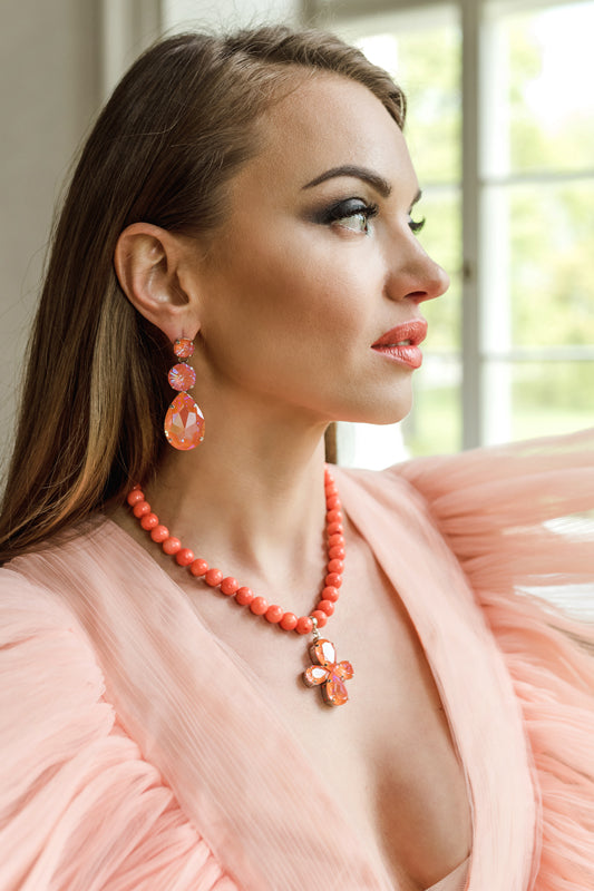 Orange coral necklace with a floral pendant featuring orange crystals in silver – part of the Paradise Floral collection by Sildare Jewelry.