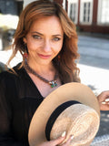 Braun beaded necklace with a floral butterfly pendant featuring green, gold, gray crystals in gold and silver tone – part of the Paradise Floral collection by Sildare Jewelry.