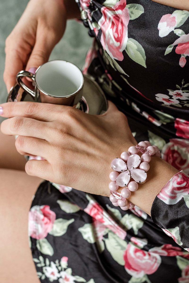 Pink double‑strand beaded bracelet with a floral gemstone centerpiece, worn on the wrist as an elegant accessory for wedding, everyday outfits and special occasions. Sildare jewelry