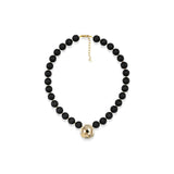 A black beaded necklace with a textured gold ball pendant and gold clasp, displayed on a clean white background.
