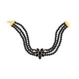 A three-strand black onyx beaded 24 carat gold plated choker necklace with a central black crystal floral cluster and gold-tone clasp ends, shown on a plain white background.
