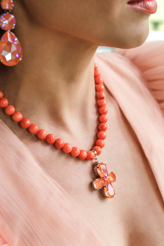 Orange coral necklace with a floral pendant featuring orange crystals in silver – part of the Paradise Floral collection by Sildare Jewelry.