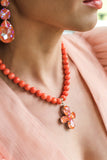 Orange coral necklace with a floral pendant featuring orange crystals in silver – part of the Paradise Floral collection by Sildare Jewelry.
