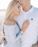 Pink double‑strand beaded bracelet with a floral gemstone centerpiece, worn on the wrist as an elegant accessory for wedding, everyday outfits and special occasions. Sildare jewelry