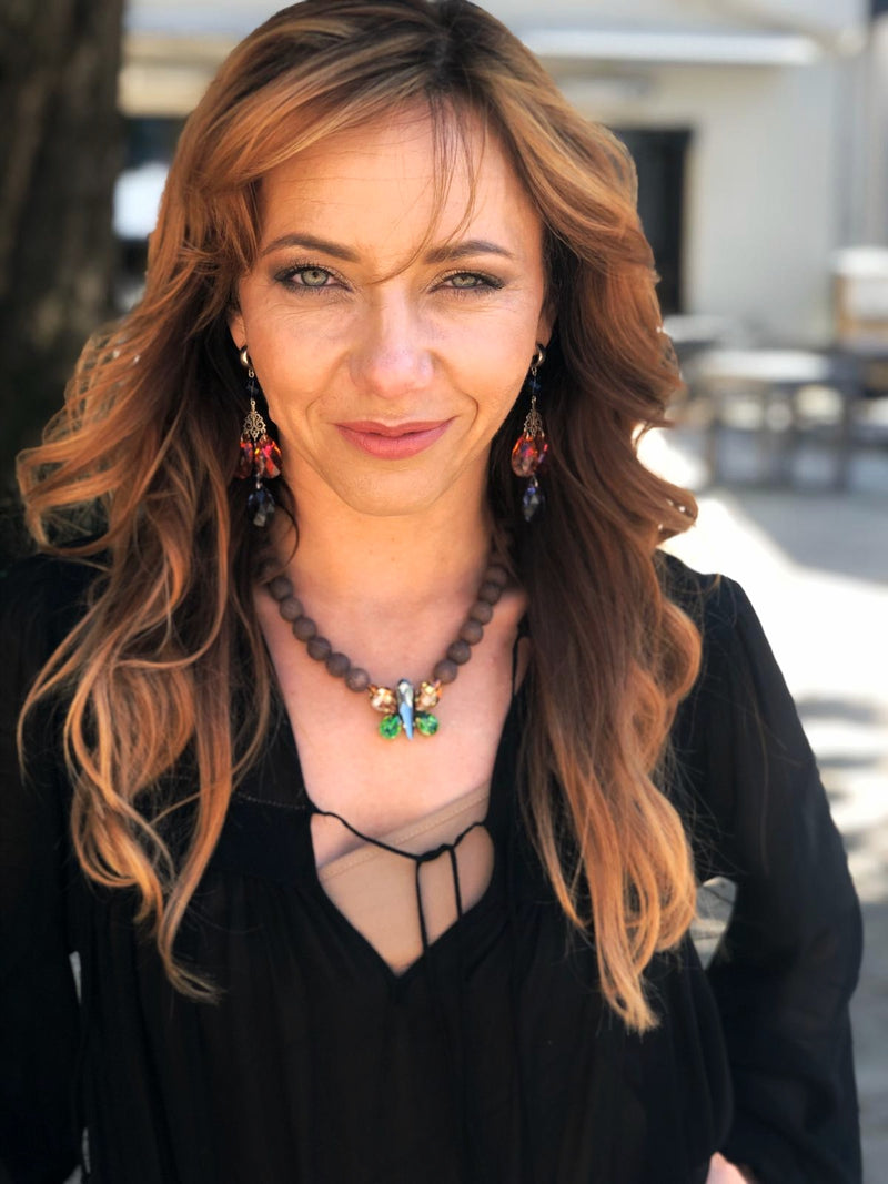 Braun beaded necklace with a floral butterfly pendant featuring green, gold, gray crystals in gold and silver tone – part of the Paradise Floral collection by Sildare Jewelry.